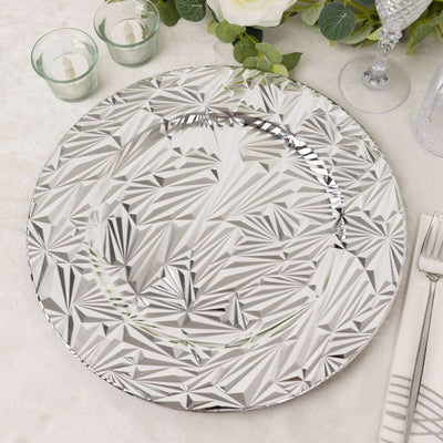 Decorative silver charger plate with geometric pattern on a table setting.