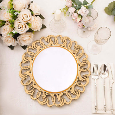Gold decorative charger plate with intricate design on a dining table setting.