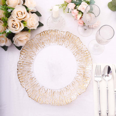 Elegant gold-trimmed glass plate on a beautifully set dining table.