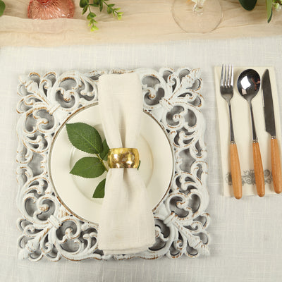 Decorative table setting with intricate plate, napkin, and cutlery.