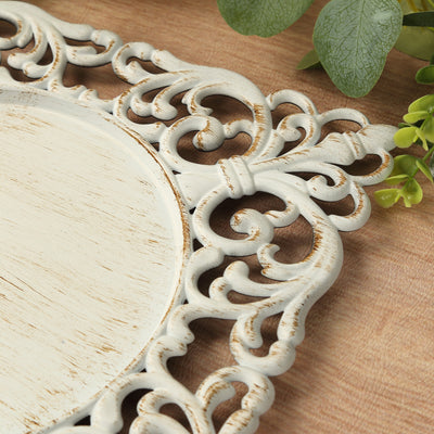 Decorative vintage mirror frame with intricate scrollwork and distressed finish.