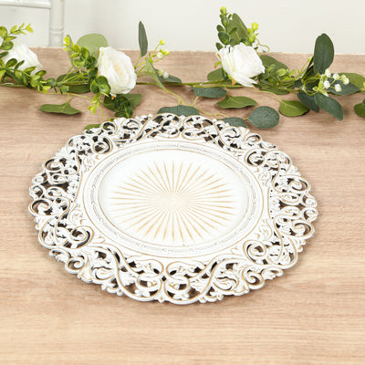 Decorative round silver platter with intricate scrollwork design.