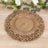 Ornate decorative gold plate with intricate floral design on wooden surface.