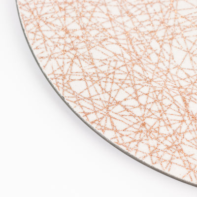 Decorative plate with a rose gold geometric pattern on a white background.