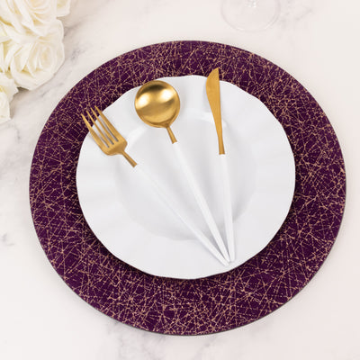 Elegant white plate with gold cutlery on a purple decorative charger.
