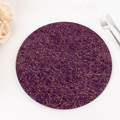 Purple decorative plate with gold pattern on a plain background.
