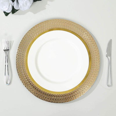 Elegant gold-accented dinner plate with cutlery on a table.