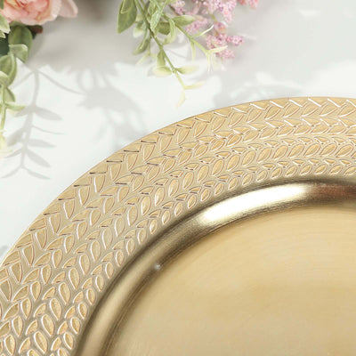 Gold decorative plate with intricate leaf design on edge.