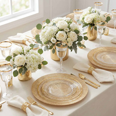 Elegant gold and white wedding table setting with floral centerpieces