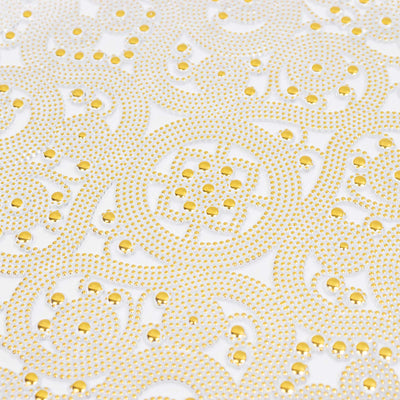 Gold and white decorative beaded pattern with water droplets on fabric