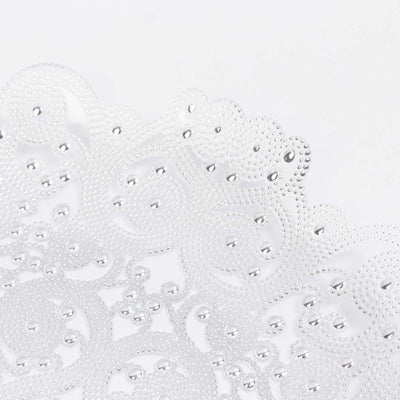 White beaded lace fabric with clear water droplets, close-up texture
