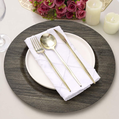 Elegant gold flatware set on white napkin over rustic wood charger plate
