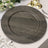 Round dark wood charger plate on elegant white table setting with gold accents