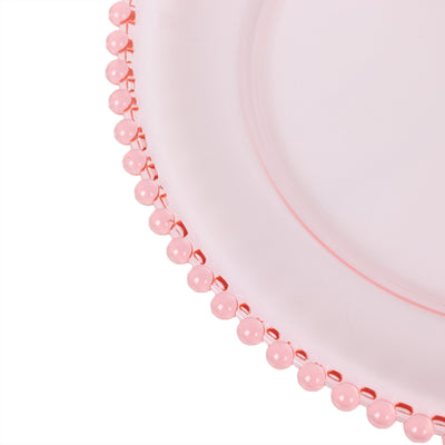 Pink decorative plate with beaded rim detail.
