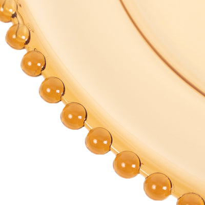 Amber decorative plate with beaded edge detail.