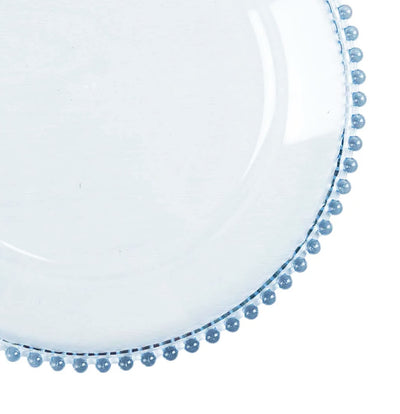 Clear glass plate with blue beaded rim on a plain background.