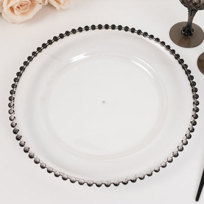 Clear glass plate with black beaded rim on white background