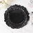 Black decorative plate with ruffled edges on a marble surface.