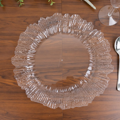 Clear decorative plate with ruffled edges on a wooden table surface.