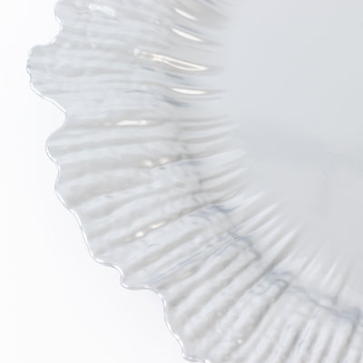 Clear decorative plate with a textured rim design.