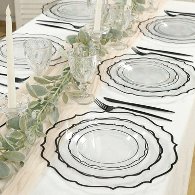 Elegant table setting with clear plates and black rim accents.