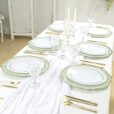 Elegant dining table set with green rimmed plates and candles.