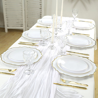 Elegant dining table setting with white plates and gold accents.