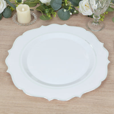 Elegant white decorative plate with scalloped edges on a wooden table setting.
