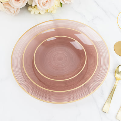 Elegant pink plate with gold rim on marble surface.