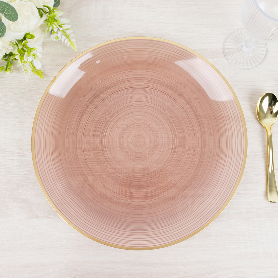 Elegant round plate with a pink wood-like design and gold rim.