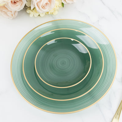 Green decorative plates with gold trim on a marble surface.