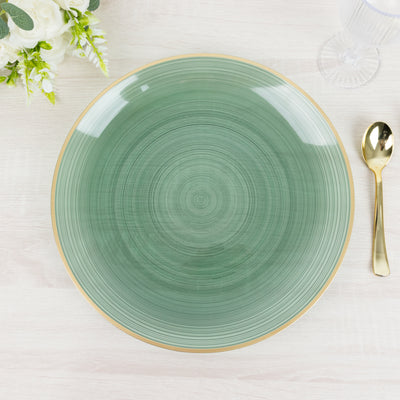 Green decorative plate with a gold rim on a light wooden table.