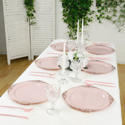 Elegant pink dinner plates set on a stylish dining table with decor.