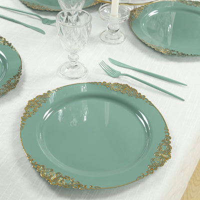 Elegant teal dinner plate with gold detailing on a dining table setting.