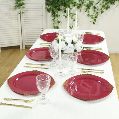 Elegant red dinner plates set on a beautifully arranged dining table.