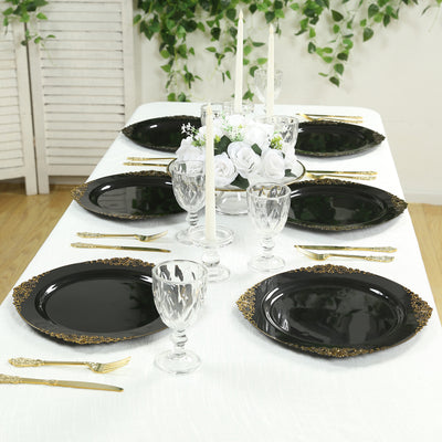 Elegant black plates with gold accents set on a beautifully arranged dining table.