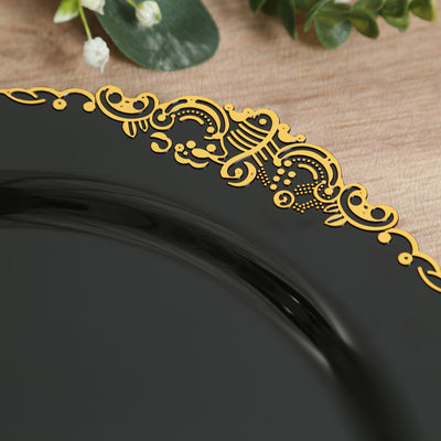 Black plate with ornate gold trim on a wooden surface.
