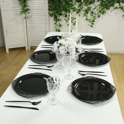 Elegant black dinner plates set on a dining table with decorative accents.