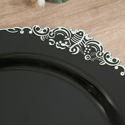 Elegant black plate with intricate white detailing on the rim.