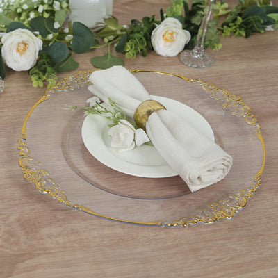 Elegant clear charger plate with gold rim, styled with napkin and floral accents.