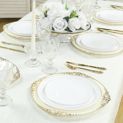 Elegant table setting with gold-accented plates and floral centerpiece.