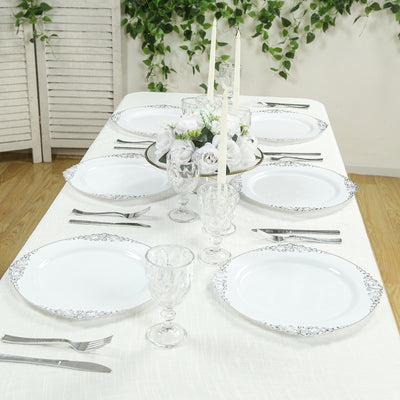 Elegant table setting with white plates and crystal glassware.