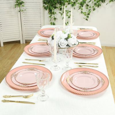 Elegant pink dinnerware set with gold accents on a beautifully arranged table.