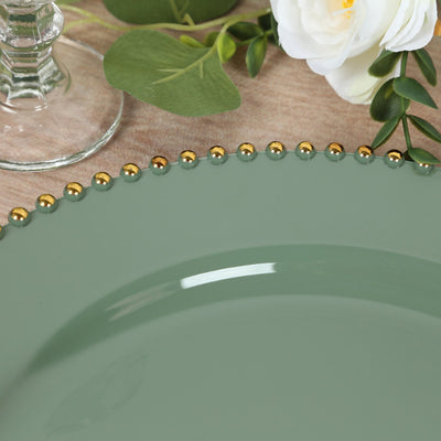 Green decorative plate with gold beaded rim and floral accents.