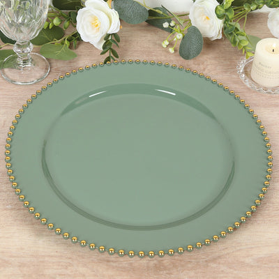 Green decorative plate with gold beaded rim on a wooden table.