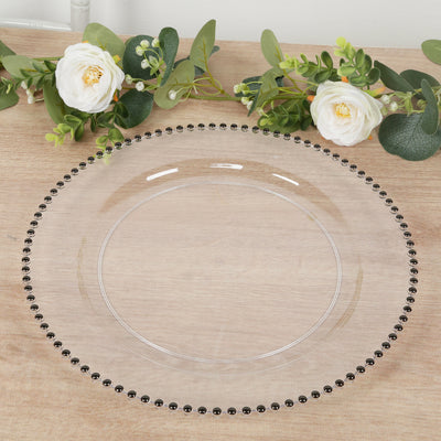 Clear glass charger plate with beaded edge and floral decor.