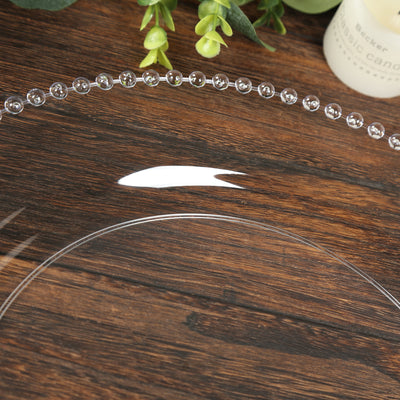 Clear decorative tray with bubble design on a wooden surface.