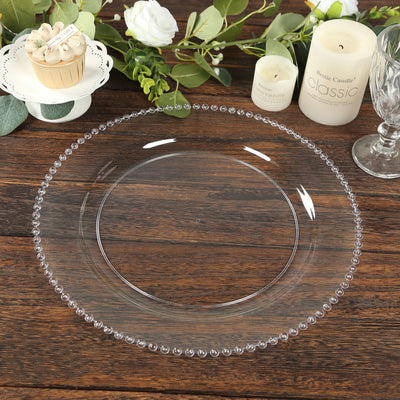 Elegant clear glass plate with beaded rim on rustic wooden table.
