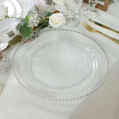 Clear charger plate with beaded rim on elegant table setting.
