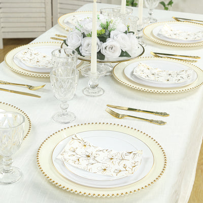 Elegant table setting with gold-accented plates and crystal glassware.